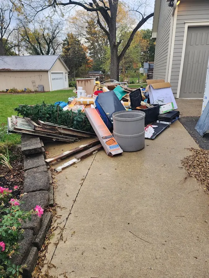 Dumpster being loaded with debris for Estate Cleanout Dumpster Rental in Waveland